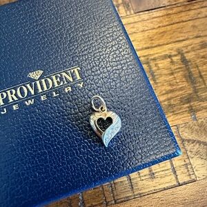 Heart shaped 14k gold pendant with three stones. Brand new.